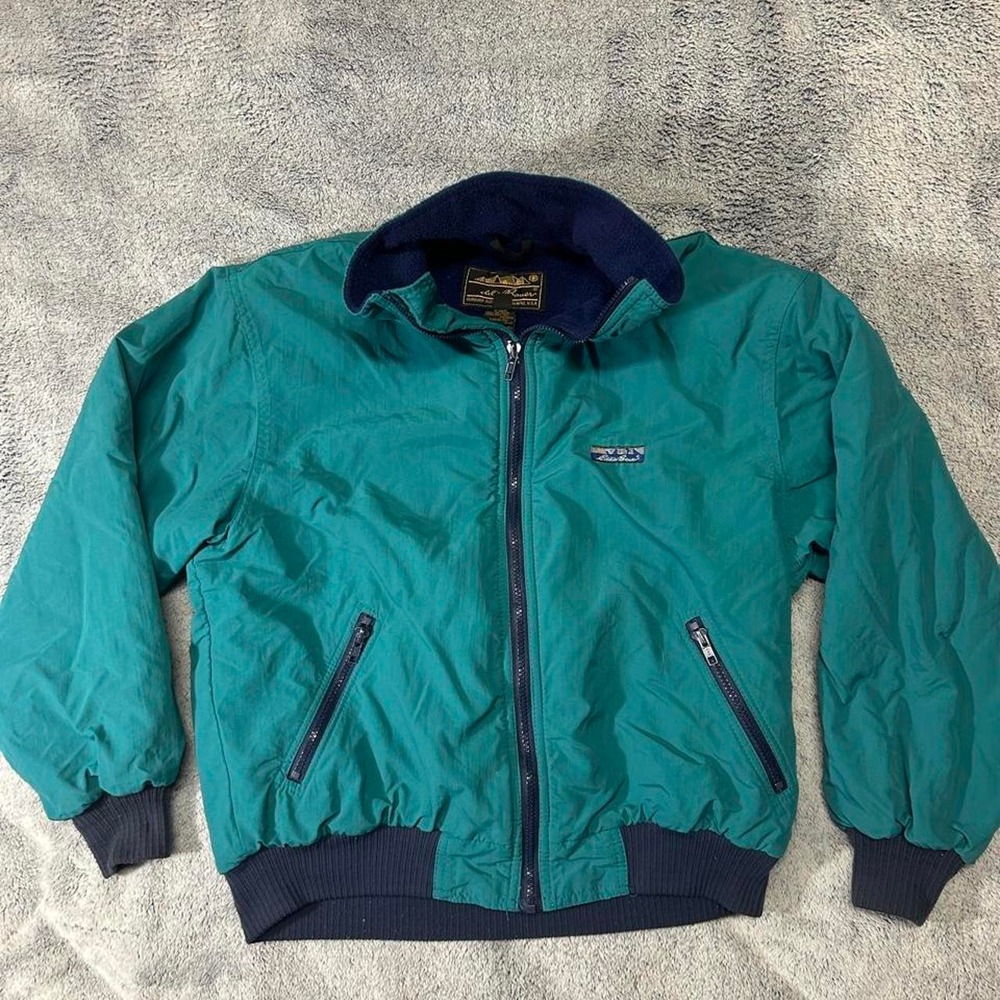 Eddie Bauer vintage teal nylon jacket featuring a navy fleece lined collar